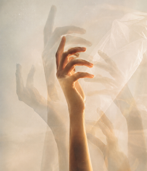 Hand reaching toward soft light